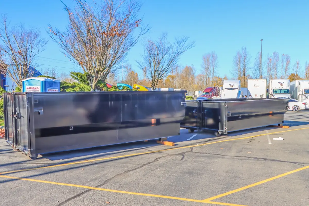 Professional dumpster rental service with roll-off container on residential driveway in Marbletown
